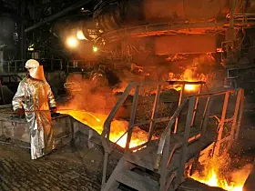 Molten hot steel pouring and worker