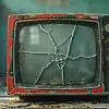 A vintage television set with a cracked screen, symbolizing the breakdown of traditional media in the digital age