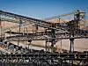 Processing Plant Lithium Mine in Western Australia. Mechanical processing used to refine lithium spodumene concentrate. Multiple conveyor belts cross into distance.