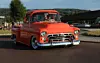 Old american chevrolet pickup truck on the road. Vintage car orange truck - retro style.