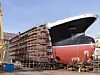 Hull of ship under construction at shipyard.