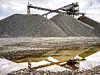 Berge von Kies in einem Kieswerk mit Förderbändern im Hintergrund