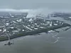 Chemical industry at terneuzen. DOW chemical park and petrochemical storage containers. Smokestacks and heay industry. Birds eye aerial drone view.