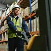 portrait of a smiling young warehouse worker working in a cash and carry wholesale store