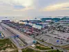 Aerial top view of container cargo ship in the export and import business and logistics international goods in urban city. Shipping to the harbor by crane in Laem Chabang, Chon Buri, Thailand