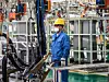 Workers in machinery factory in China.